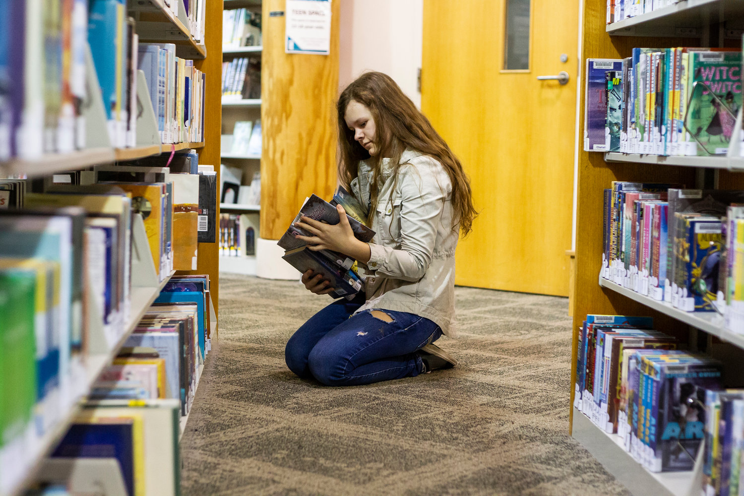 A student browses the shelves at the Lacey Timberland Regional Library on April 9, 2019.